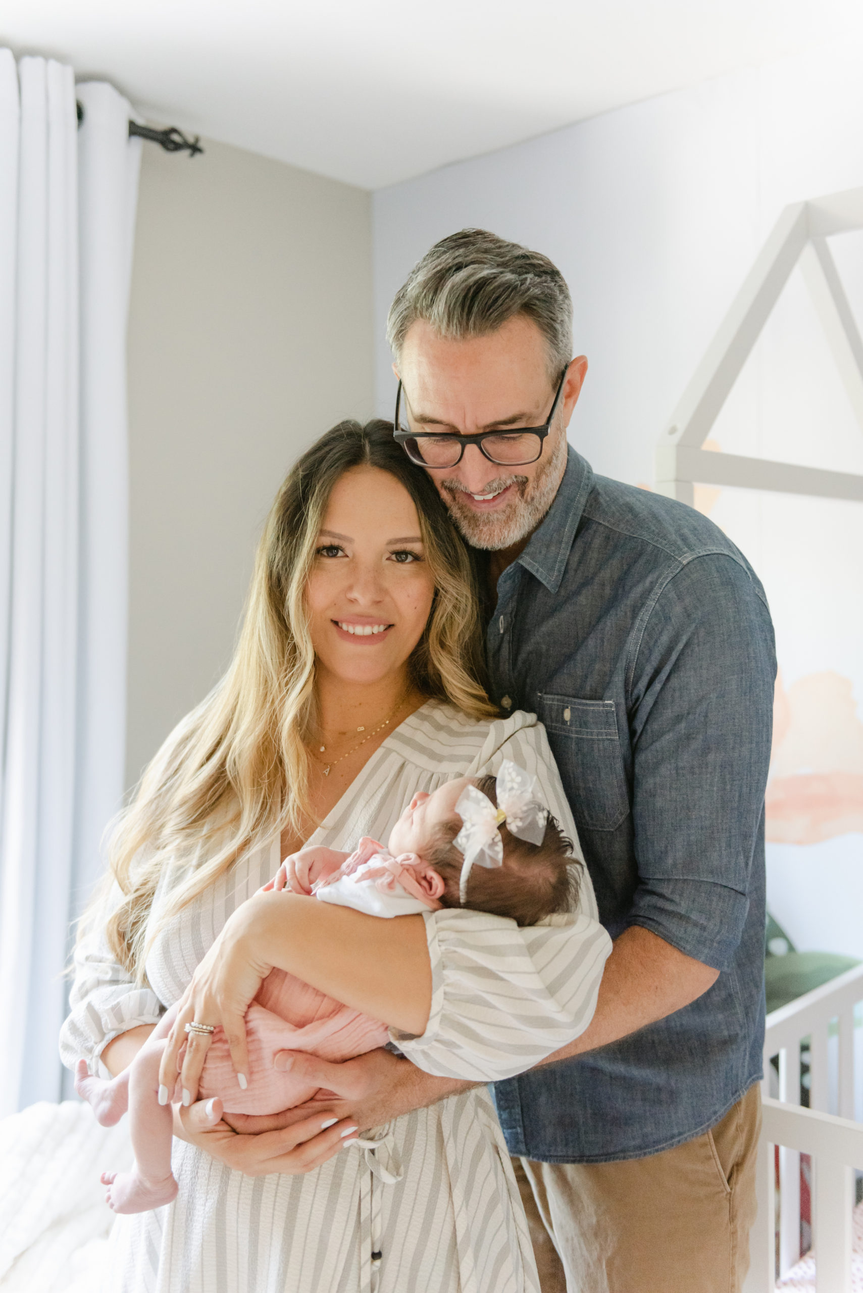 Mom holding baby, dad looking down