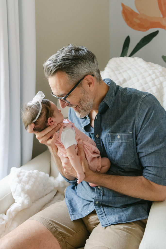 Dad snuggling baby girl