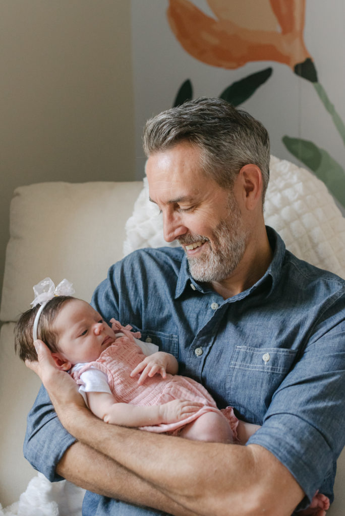 Dad smiling down at baby girl