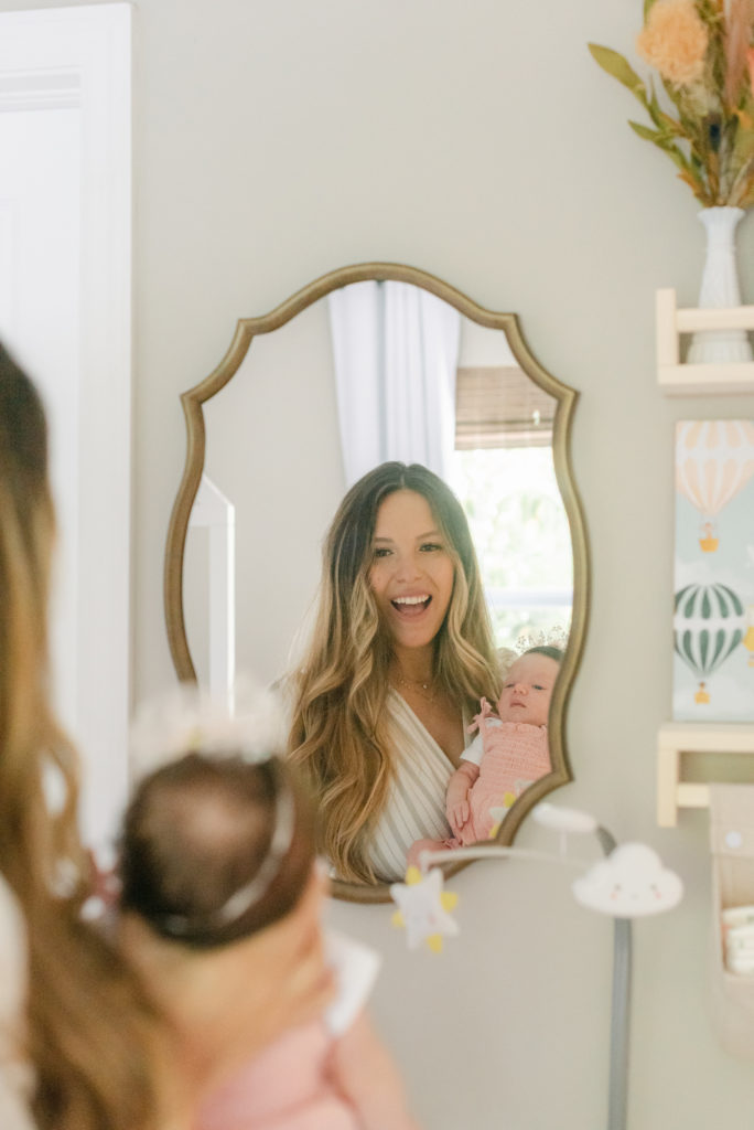 Mom and baby girl looking in the mirror