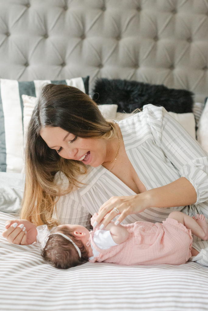 Mom leaning over baby girl