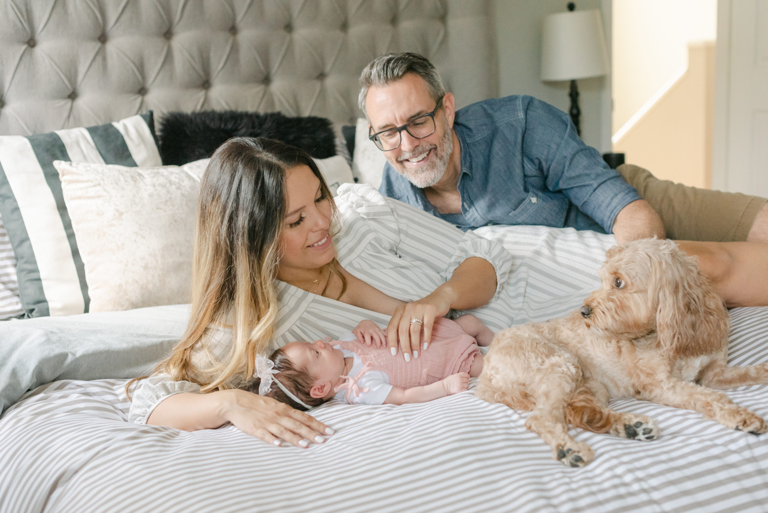 Family laying on bed