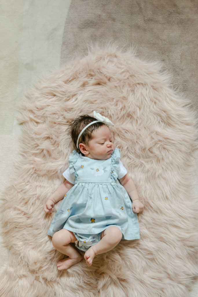 Baby girl laying on carpet