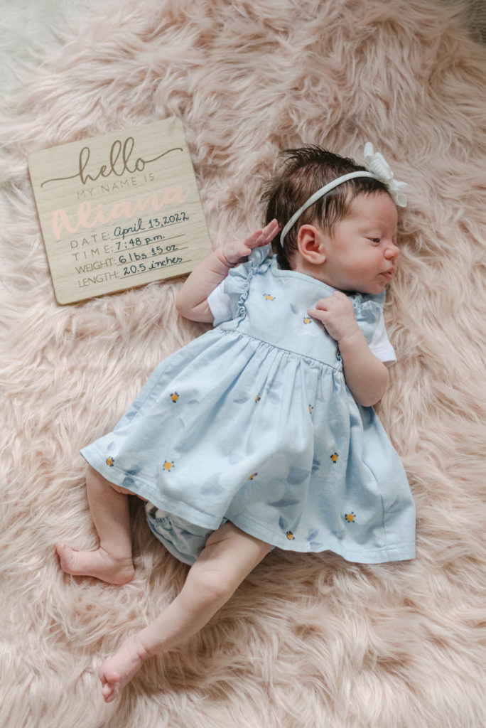 Baby girl and welcome sign