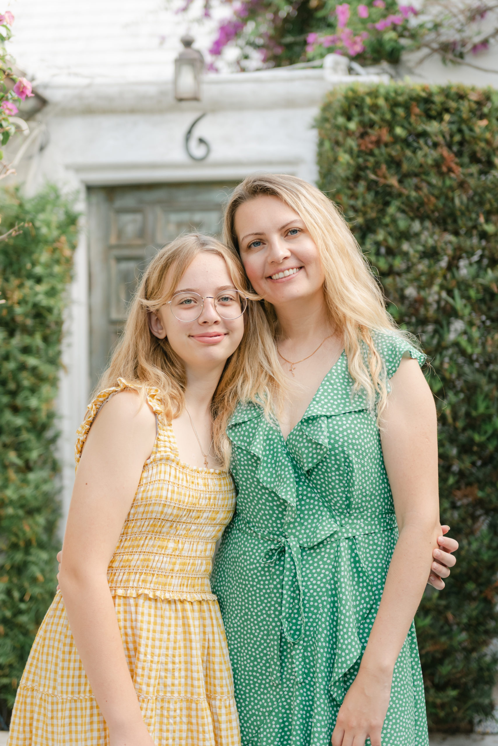 Mom and daughter, smiling at camera close up