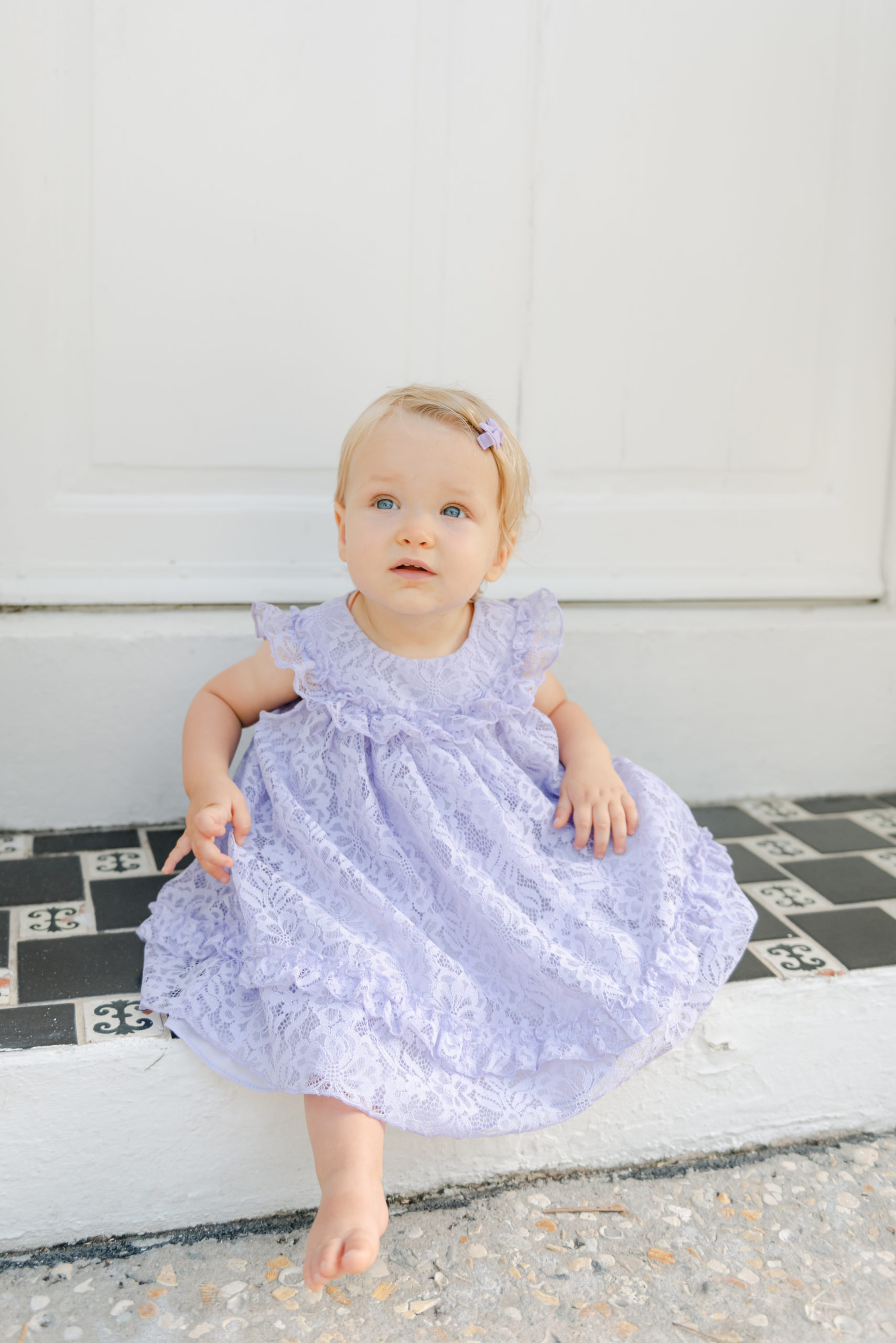 Birthday girl sitting on step smiling