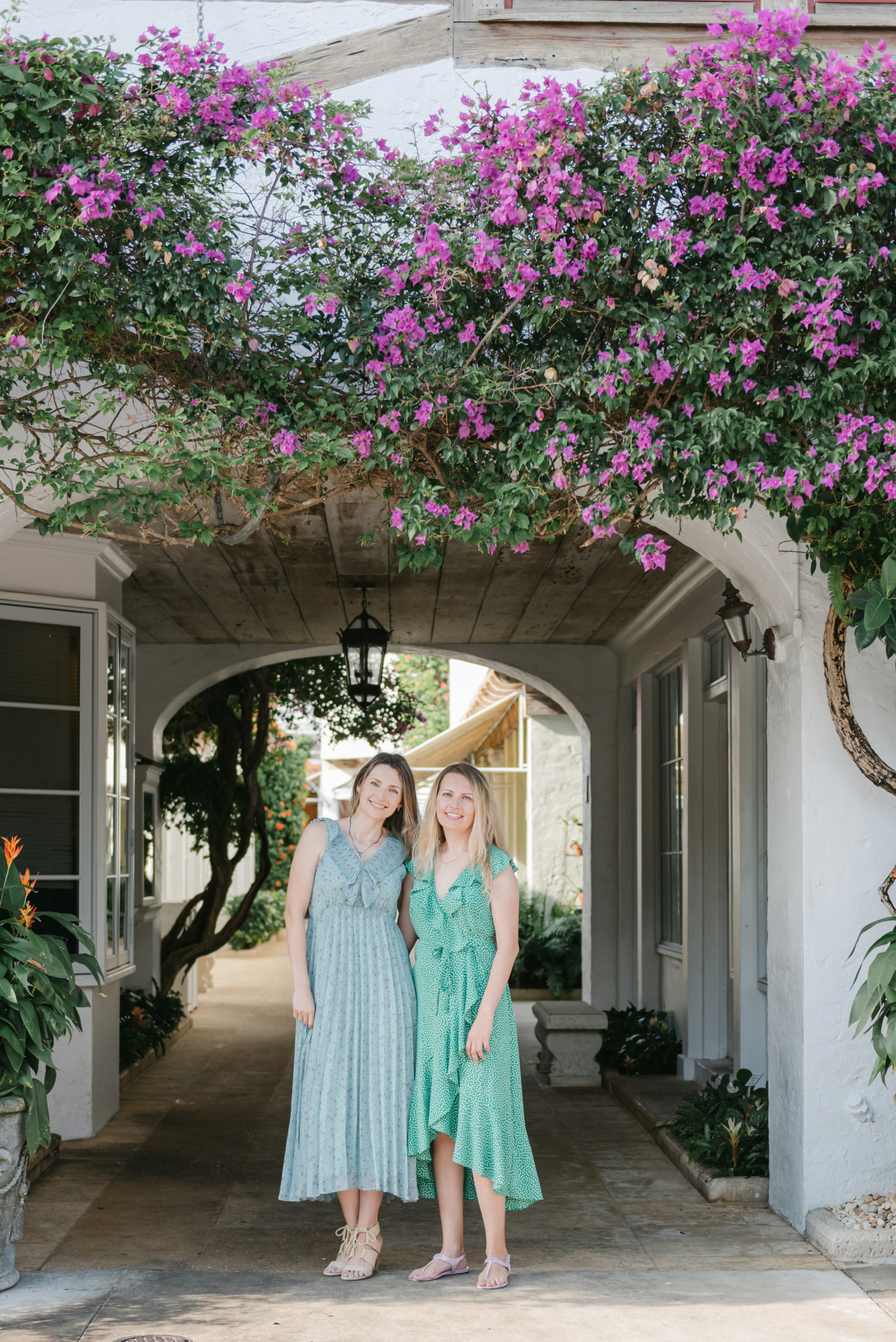 Sisters smiling under archway