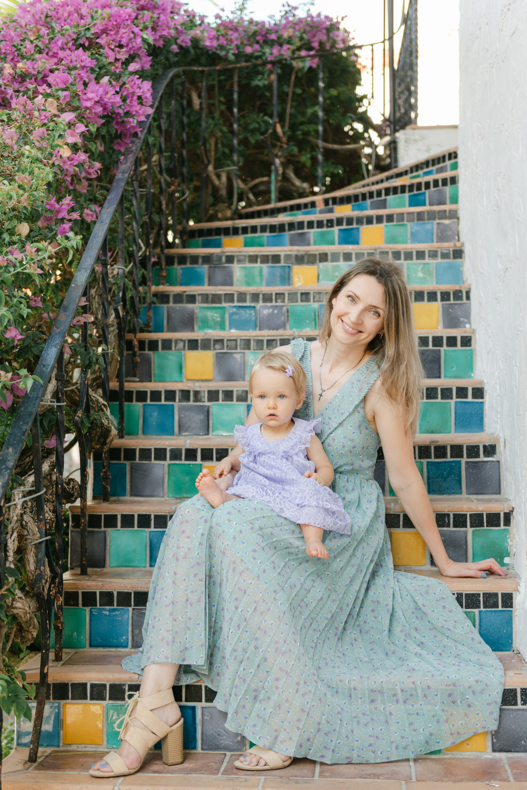 Mom and daughter smiling on steps