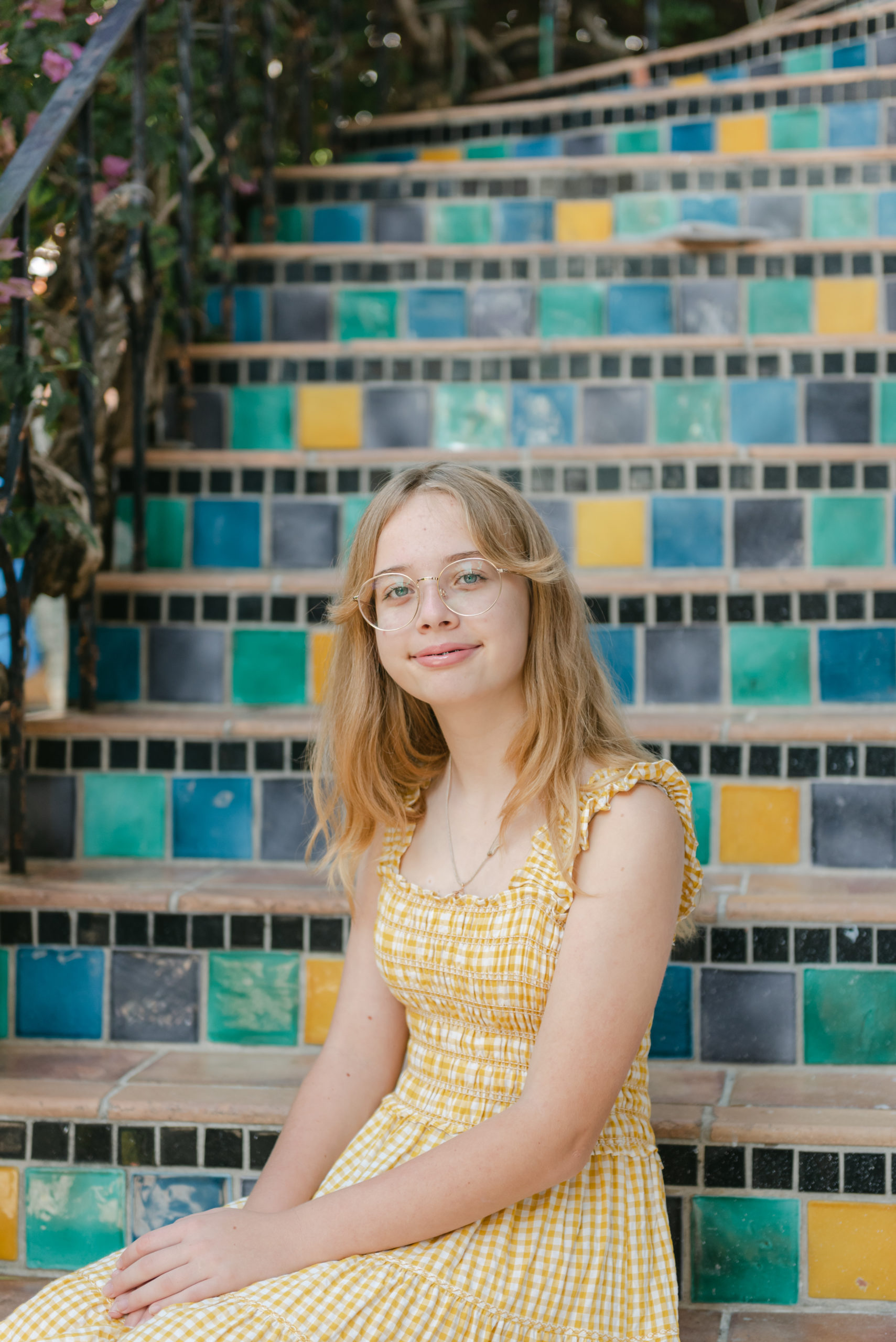 Girl sitting on colorful steps