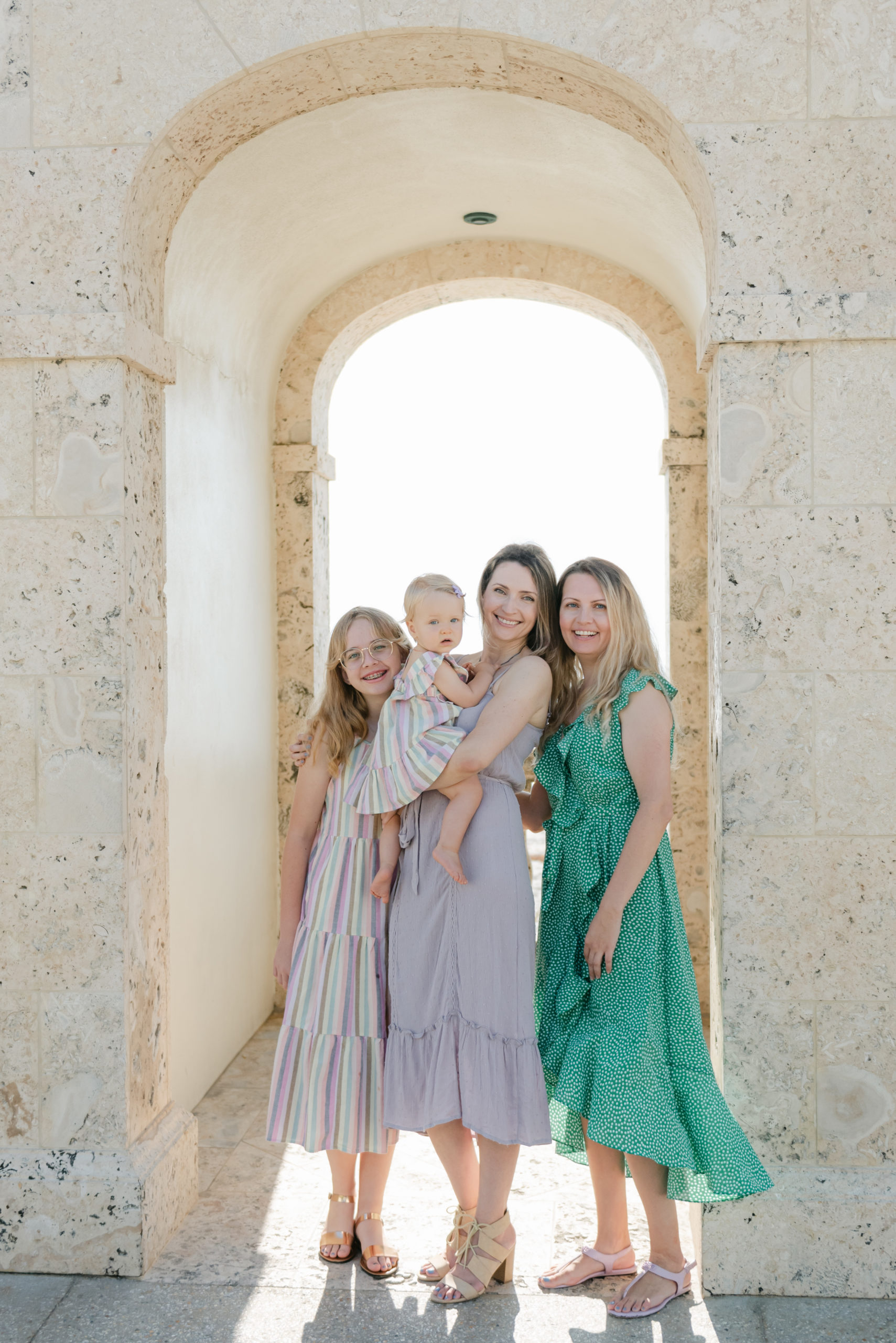 Family smiling under clock tower