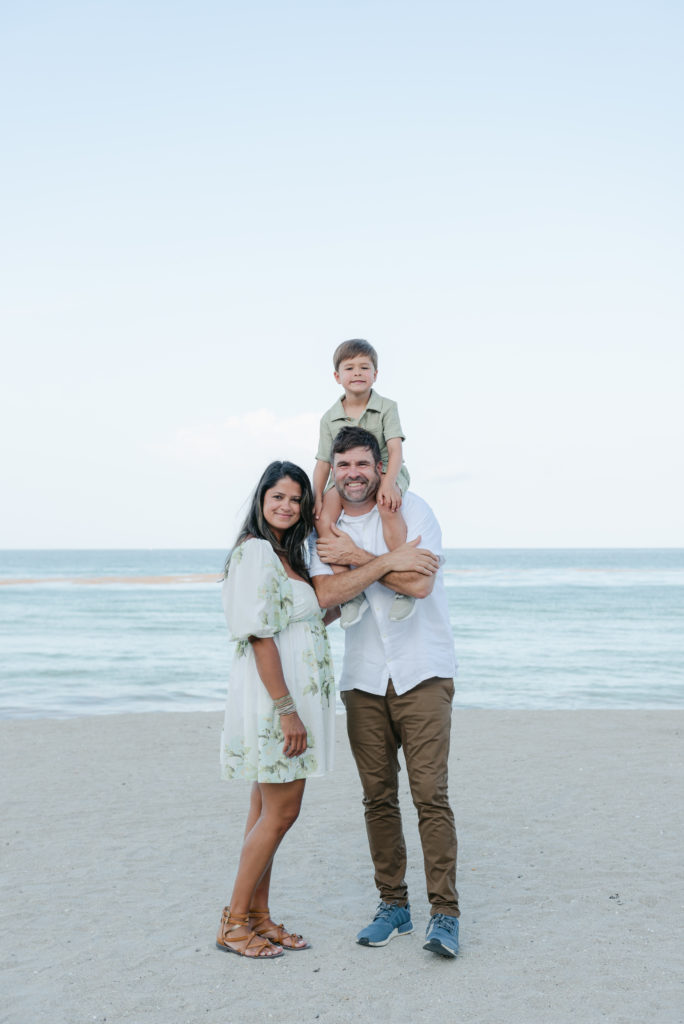 Son on dad's shoulders next to mom