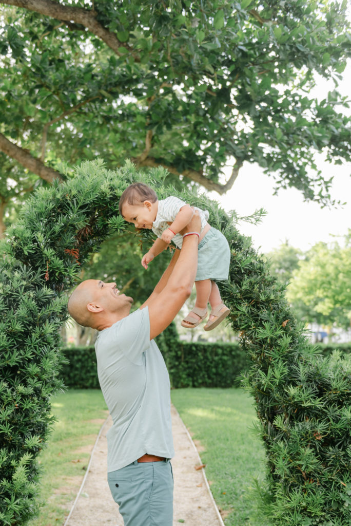 Dad lifting son up in air