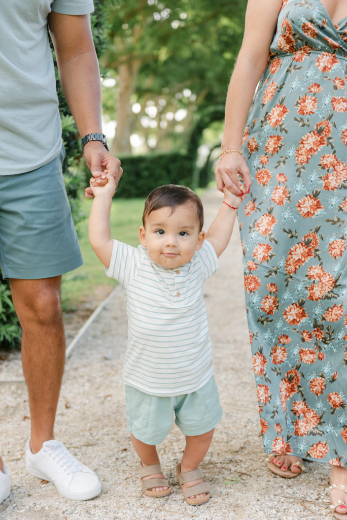 Son walking holding mom and dads hands