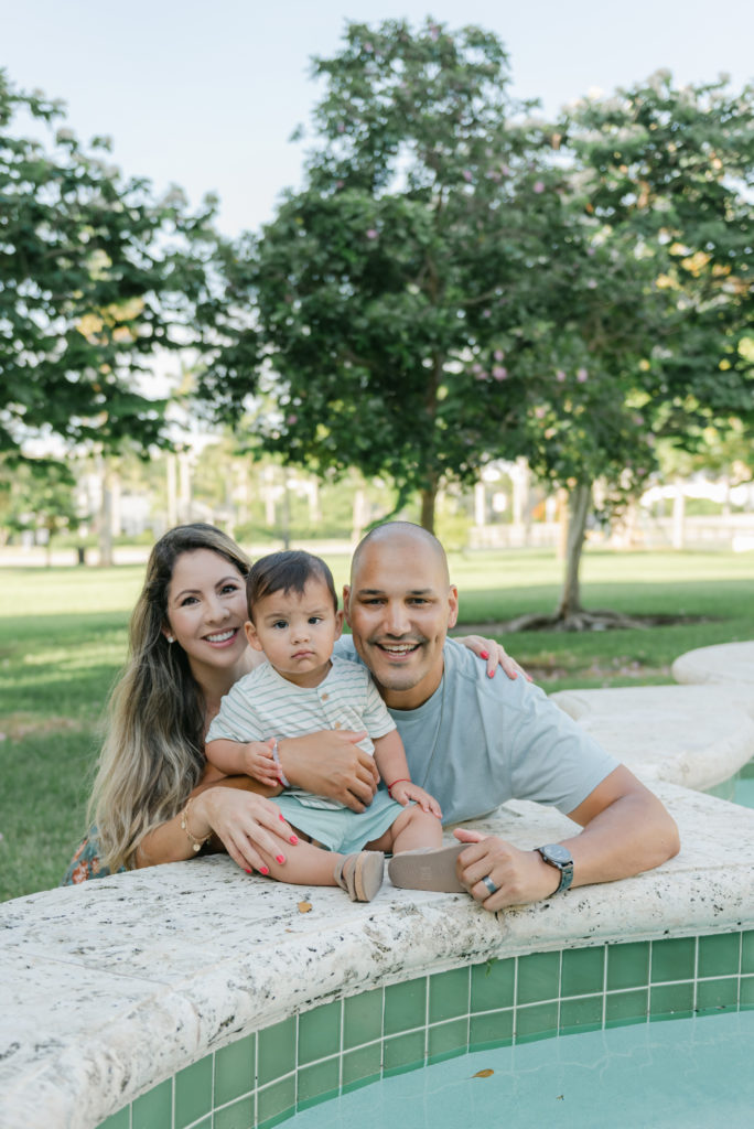 Mom, dad and son by fountain