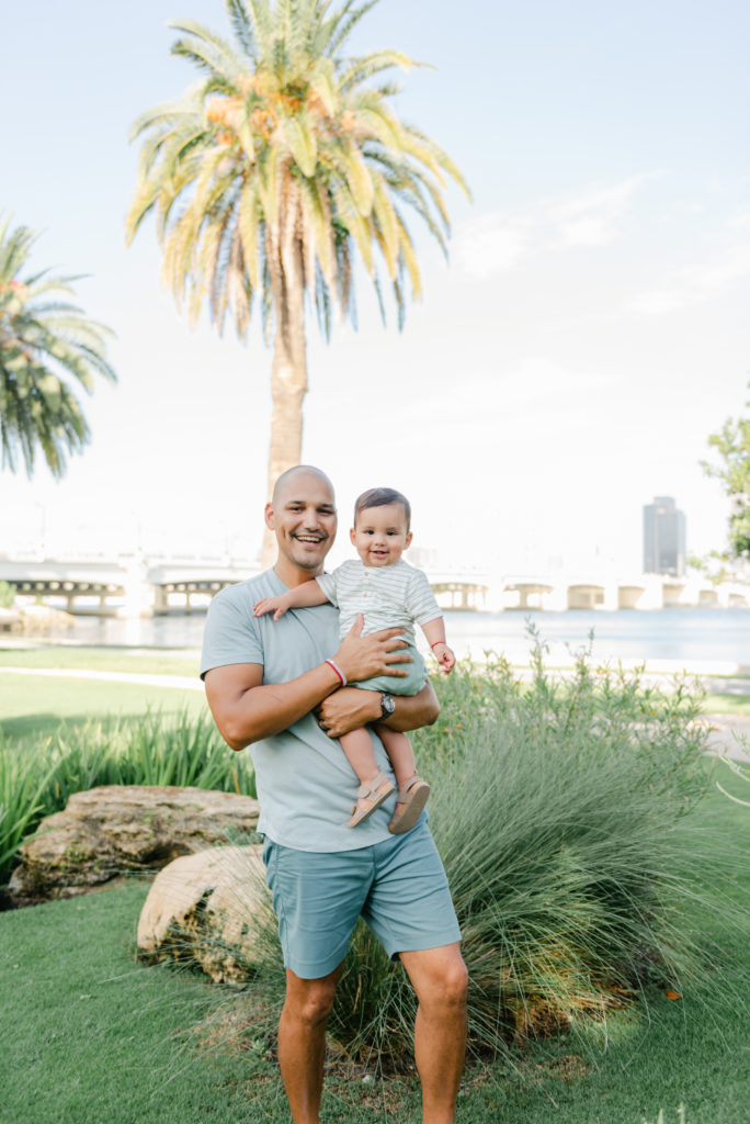 Dad holding son with intracoastal in the back