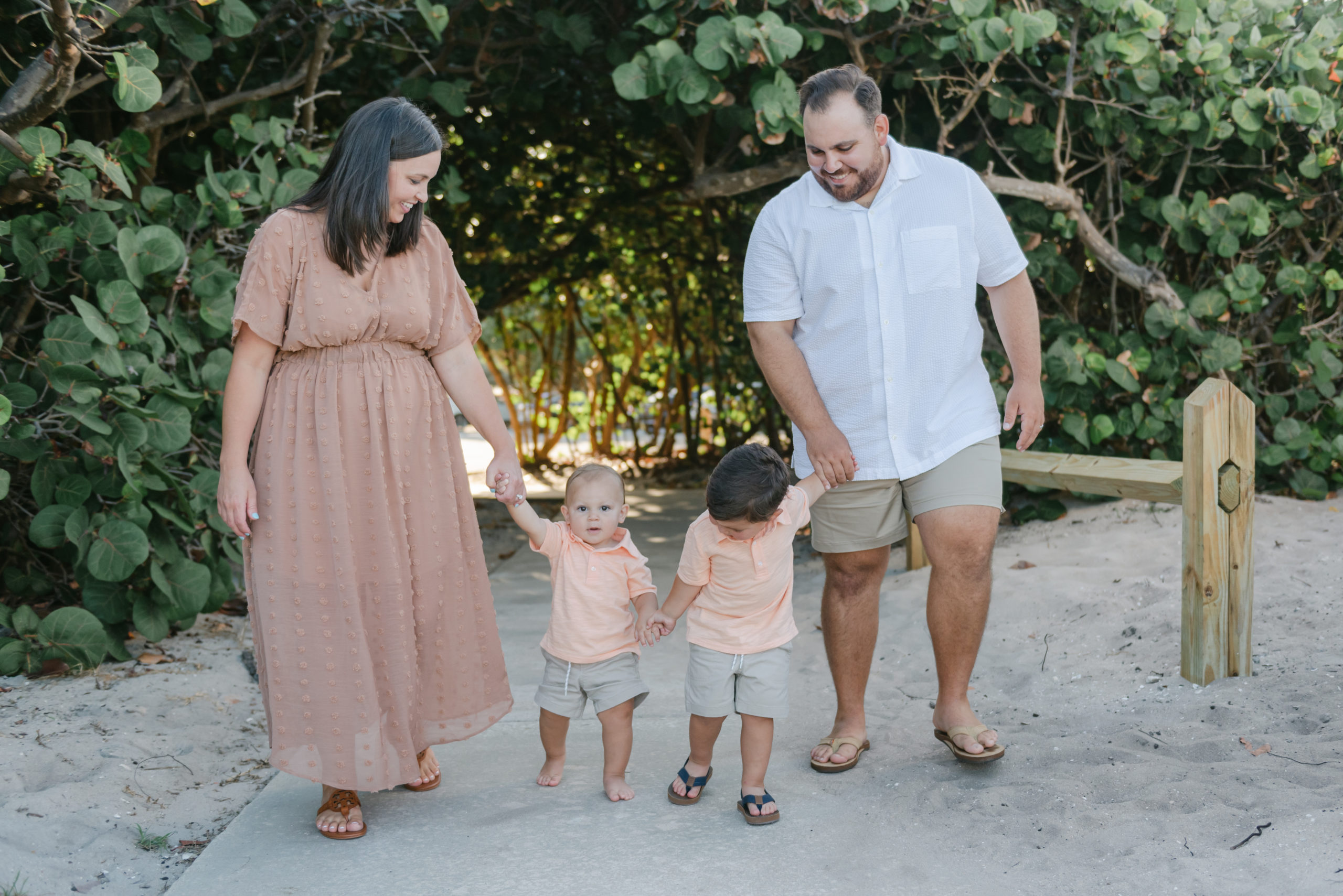 Two brothers holding hands and each holding a parents hand