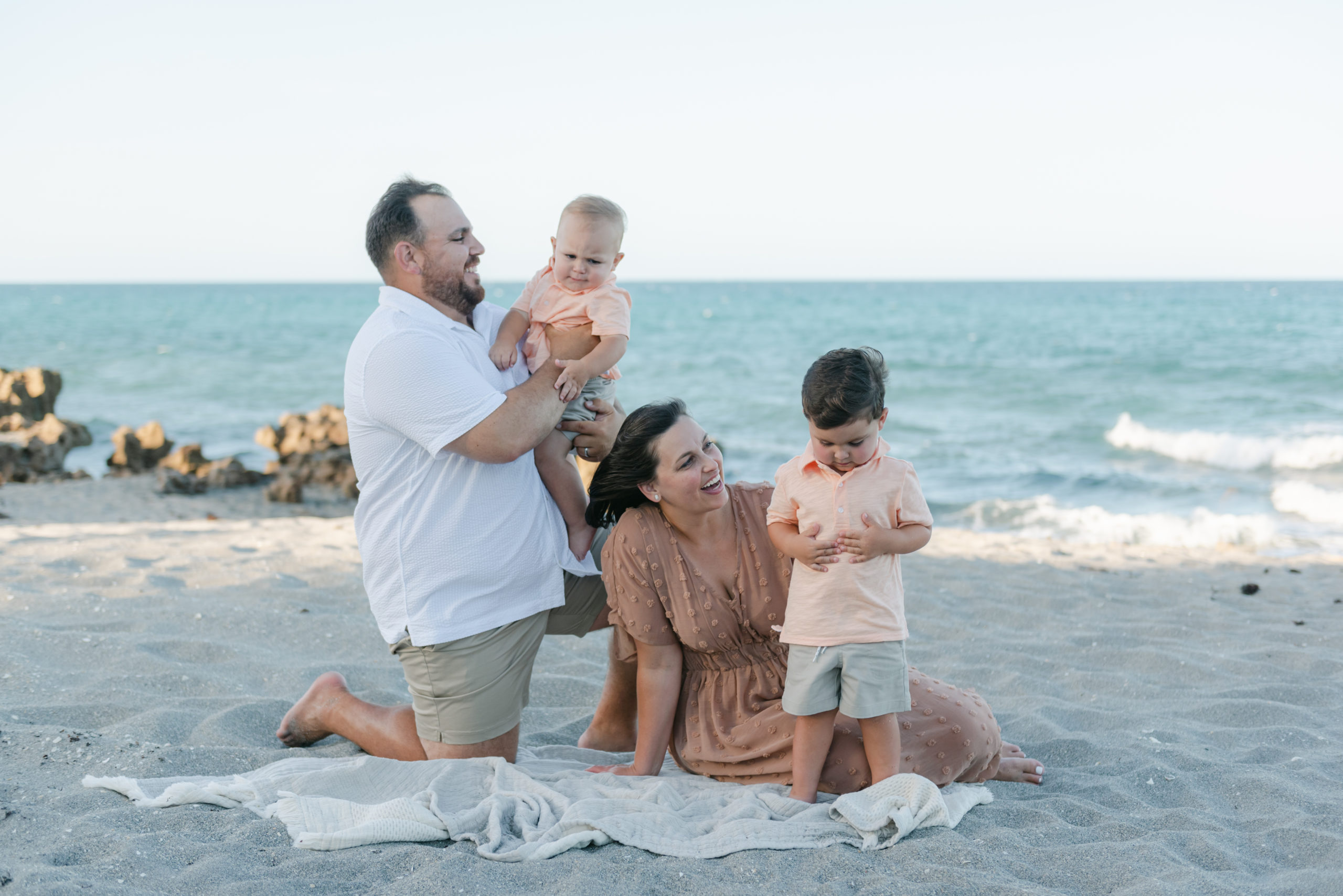 Family on blanket playing