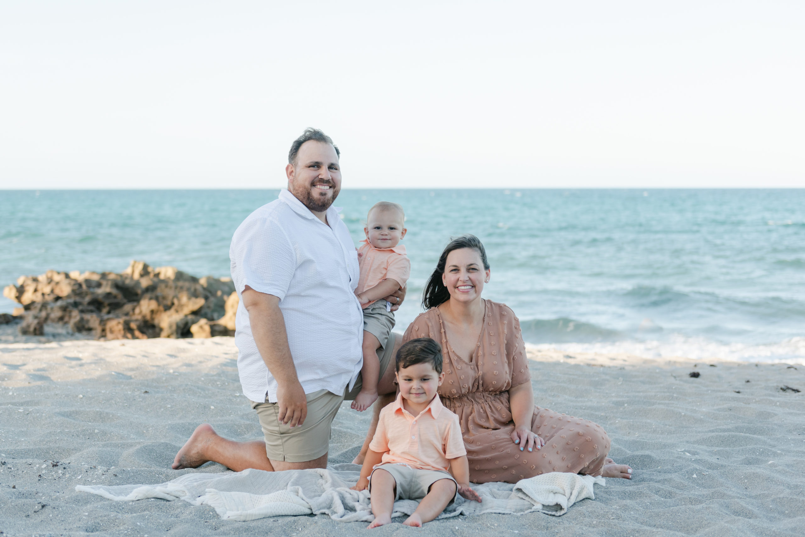 Family on blanket smiling at camera