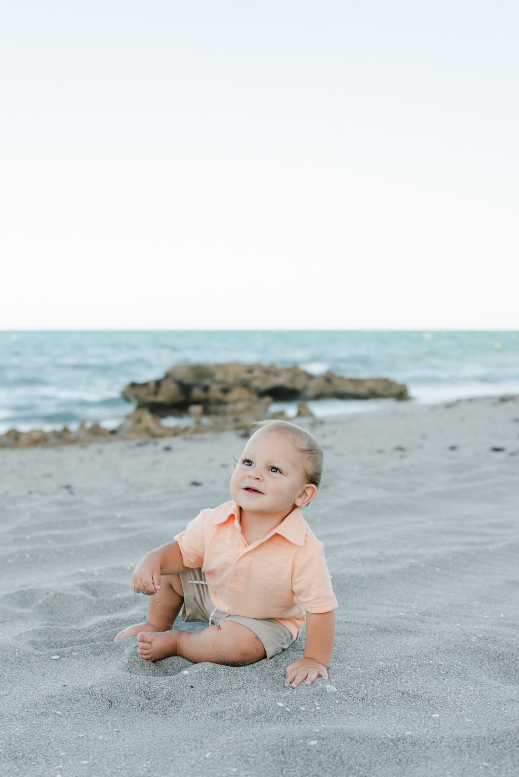 Baby sitting on the sand