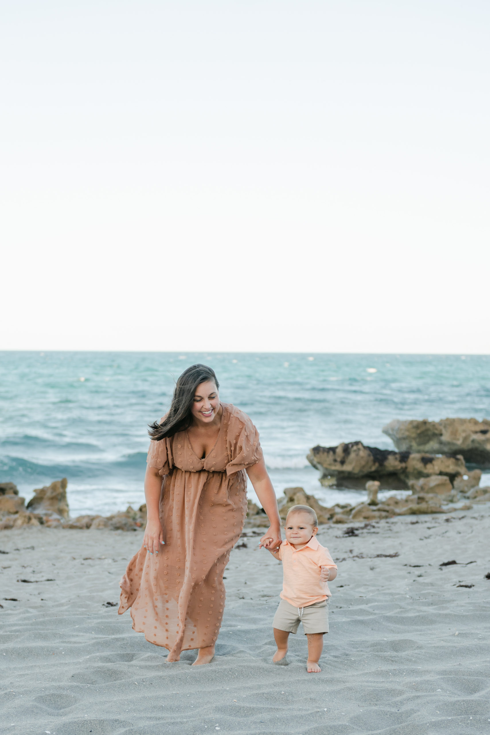 Mom holding sons hand walking