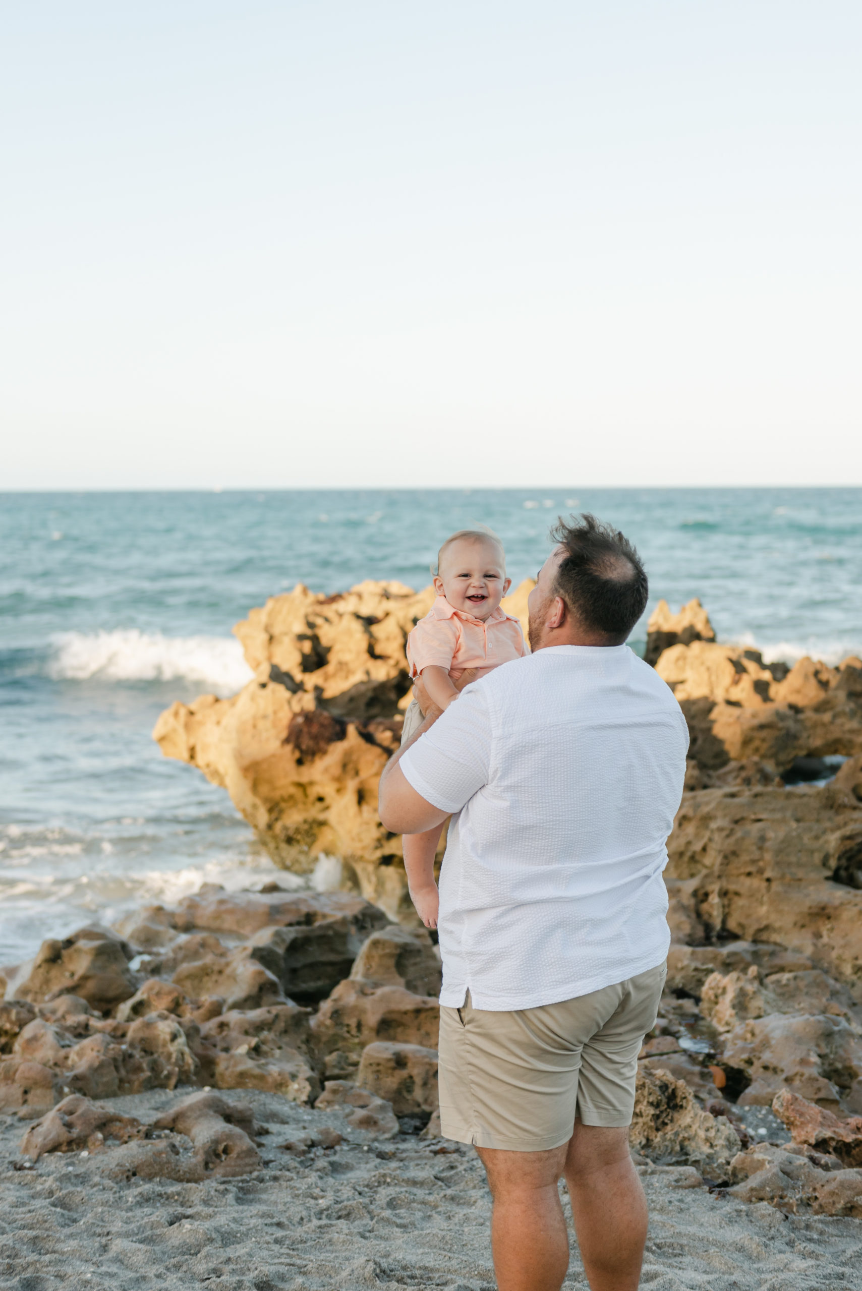 Dad holding up baby