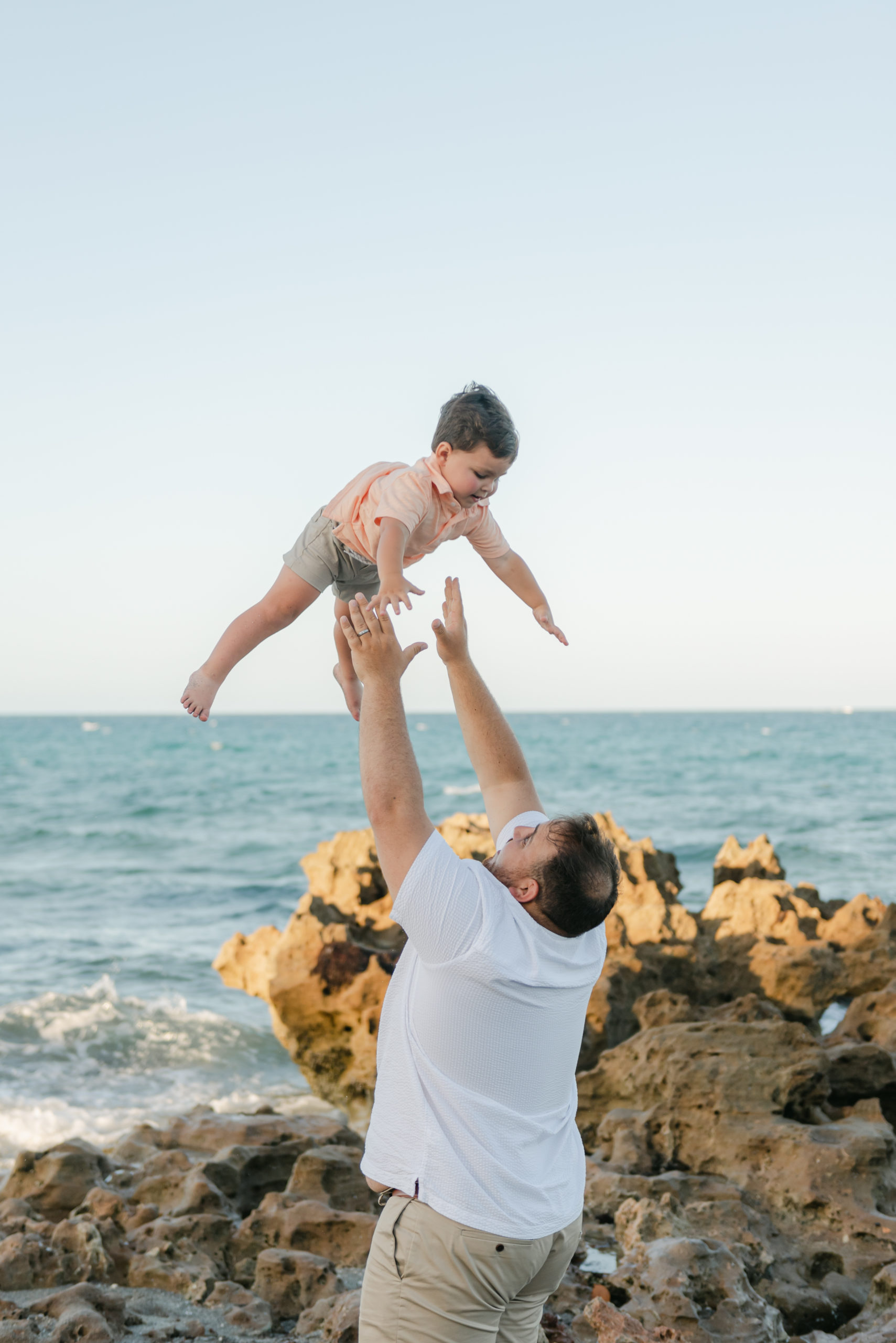 Dad throwing toddler