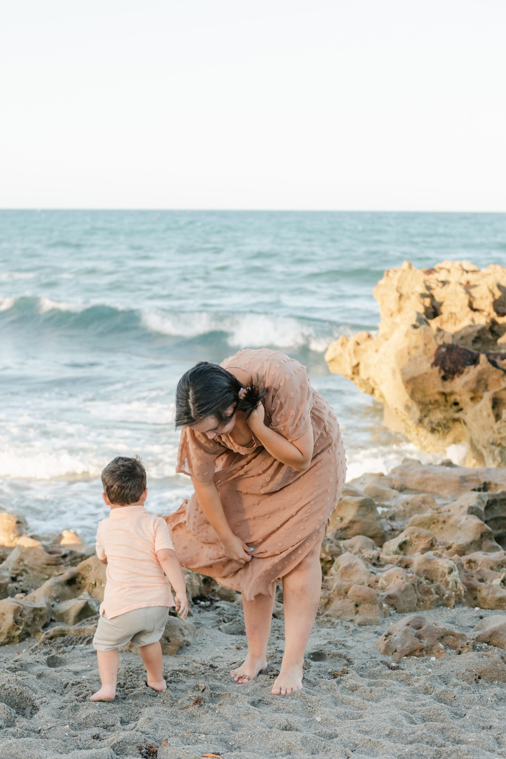 Mom and toddler looking for shells