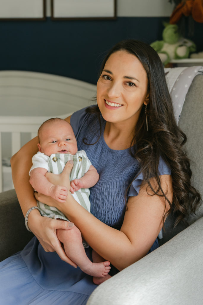 Mom sitting in glider, holding baby