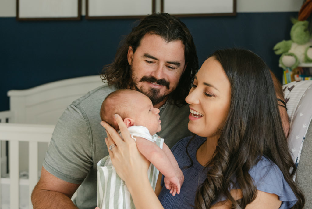 Mom and dad smiling at baby