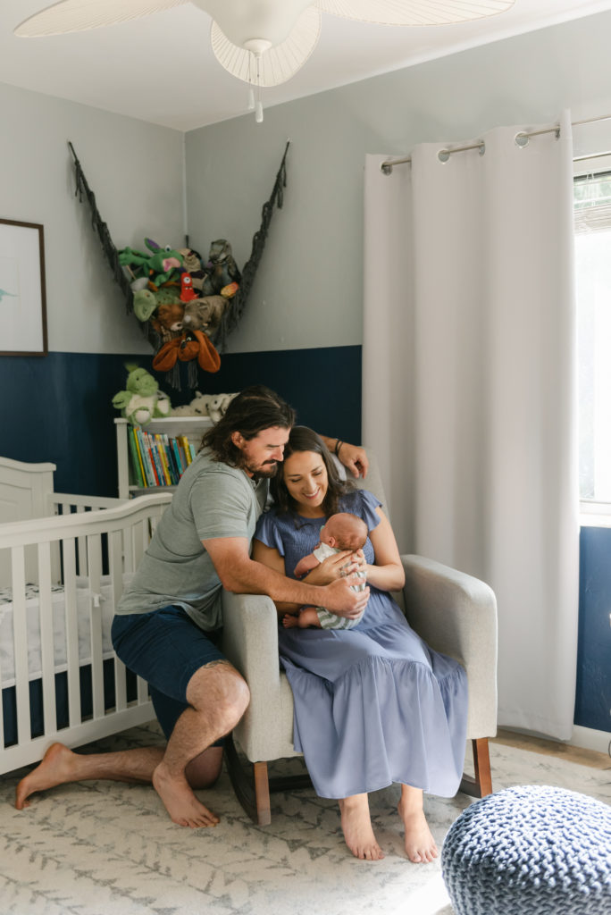 Mom and Dad sitting looking at baby