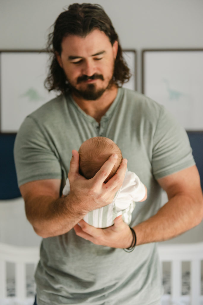 Dad holding baby's head