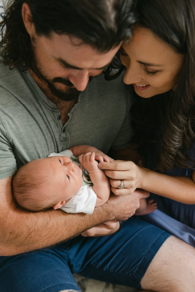 Mom and dad snuggling baby