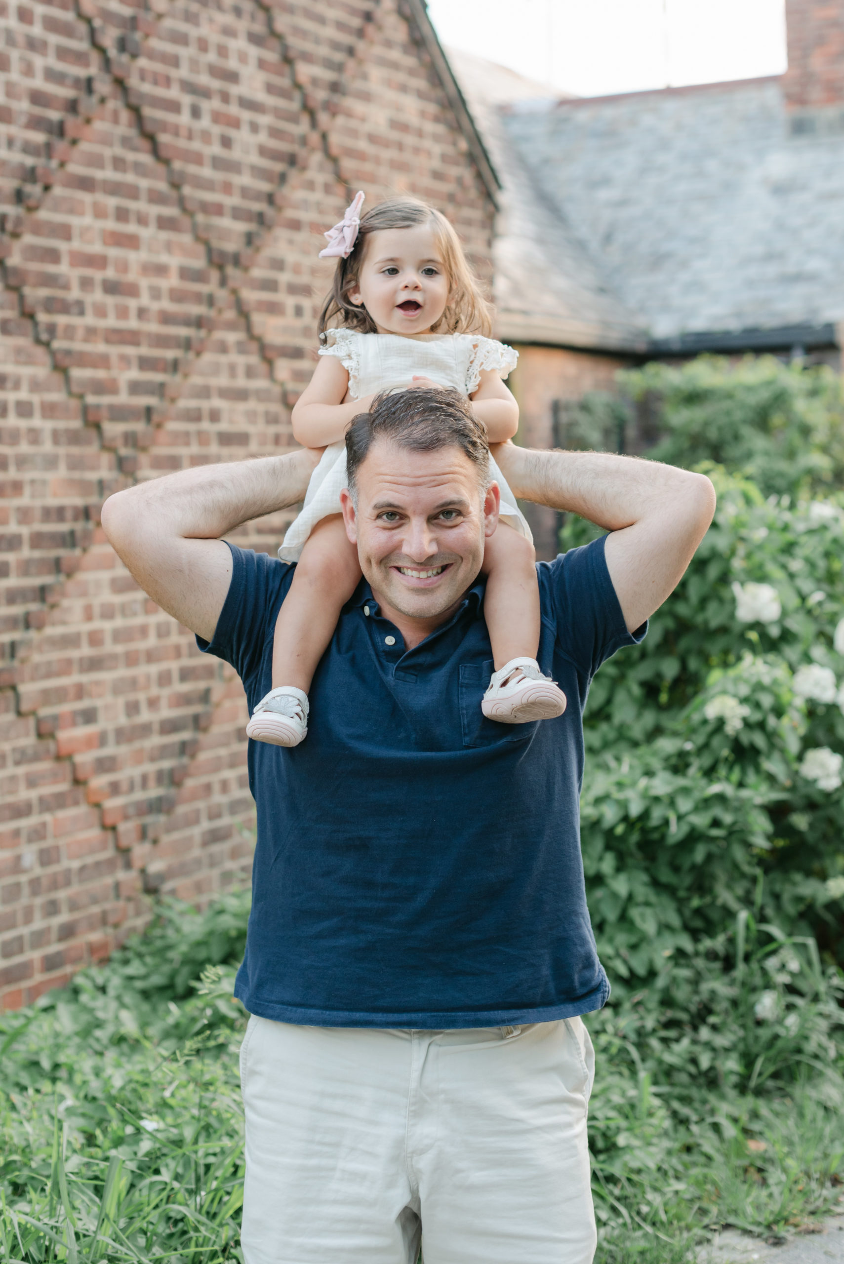 Daughter on dad's shoulders