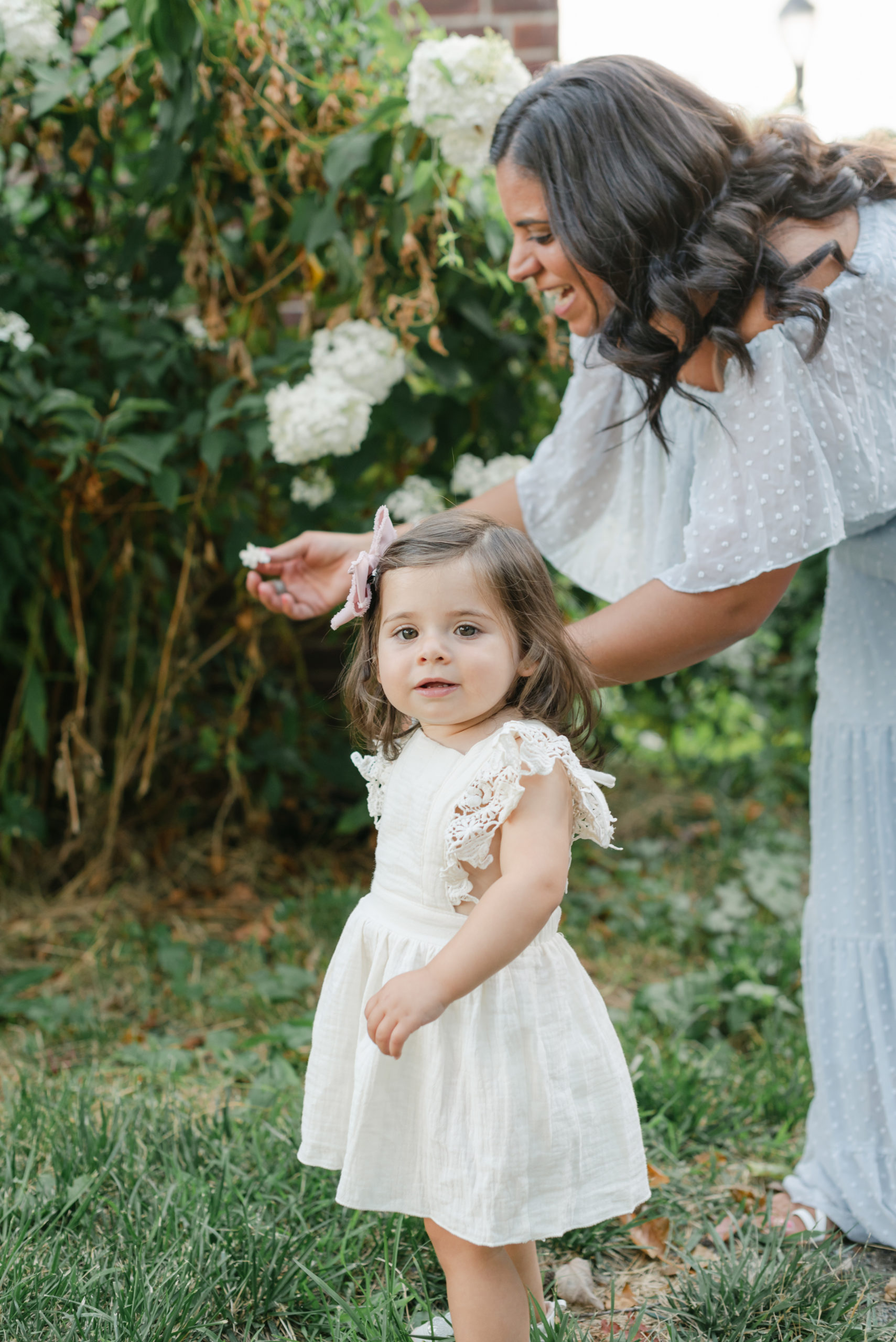 Mom and daughter playing with flowers