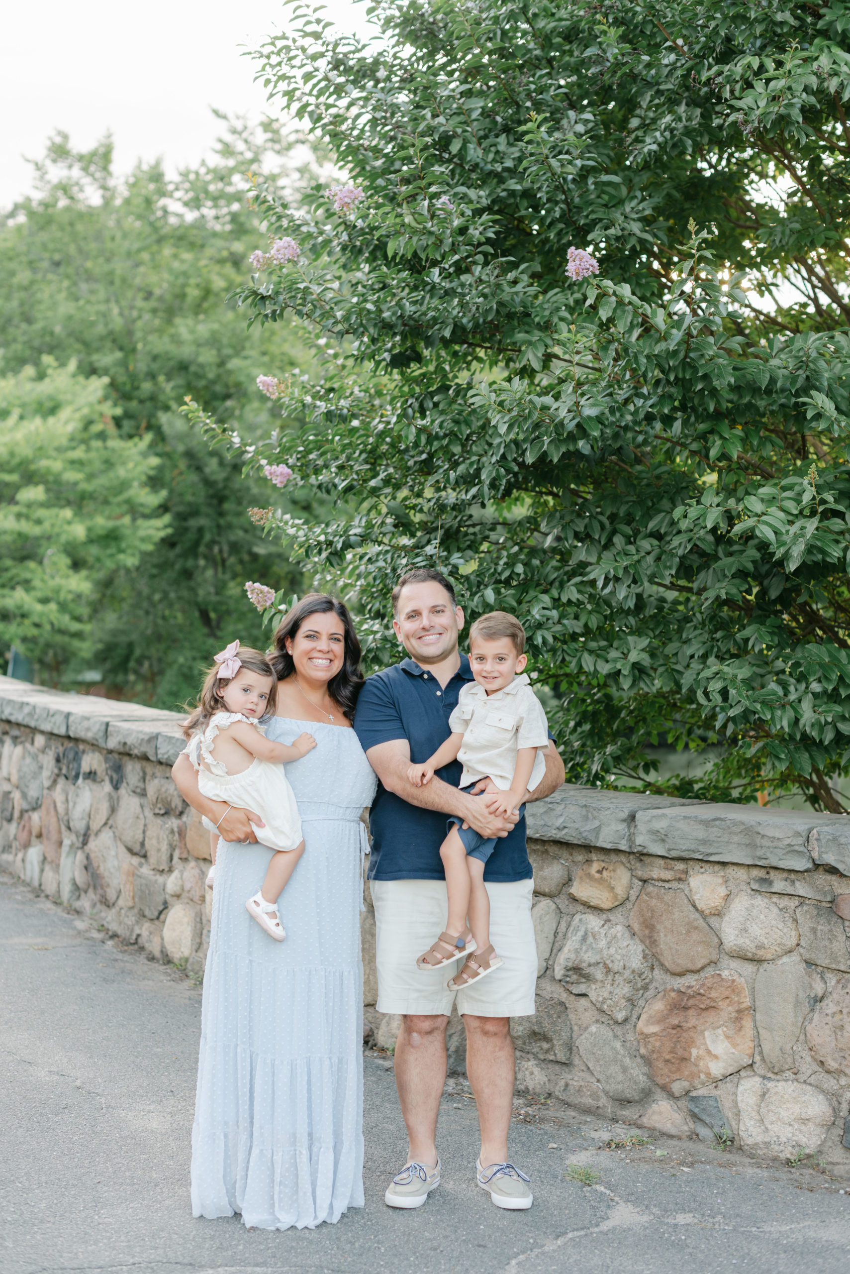 Family smiling on bridge