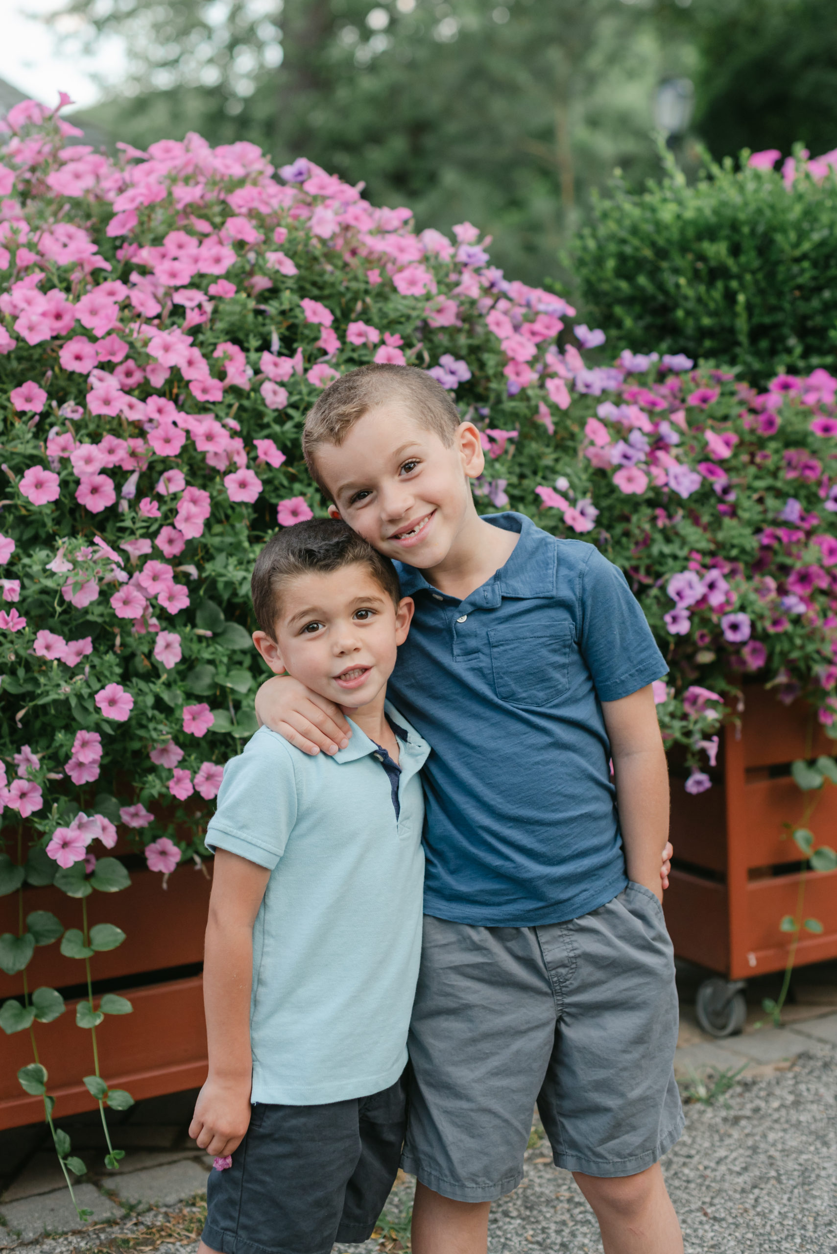 Two brothers in front of flowers