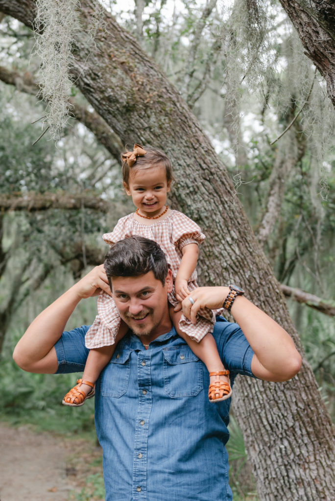 Baby girl on dad's shoulders