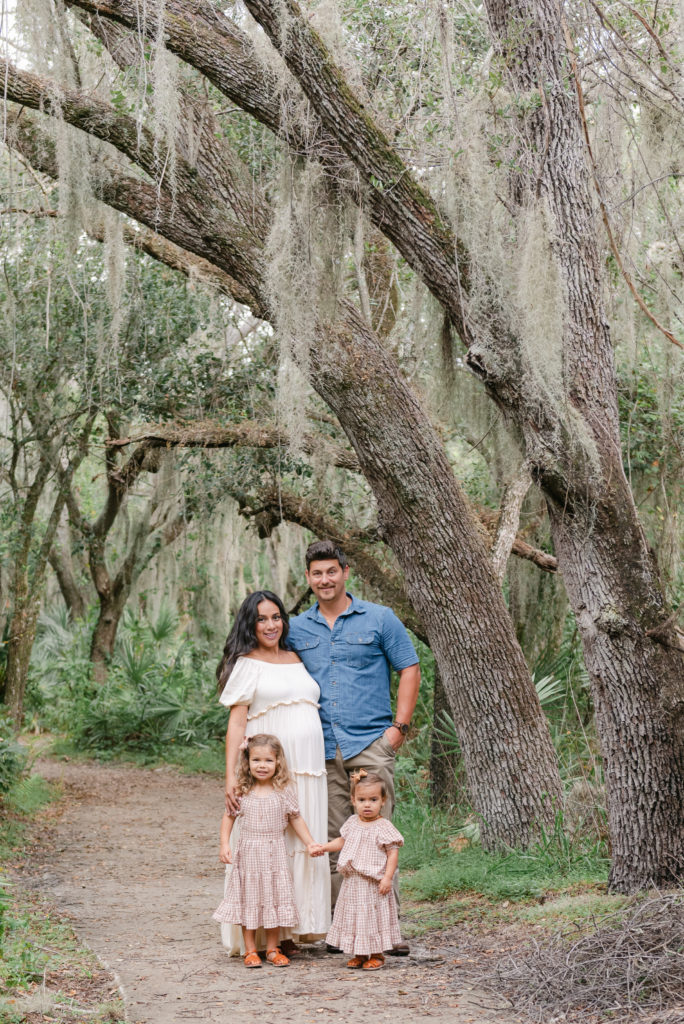 Family looking at camera under tree