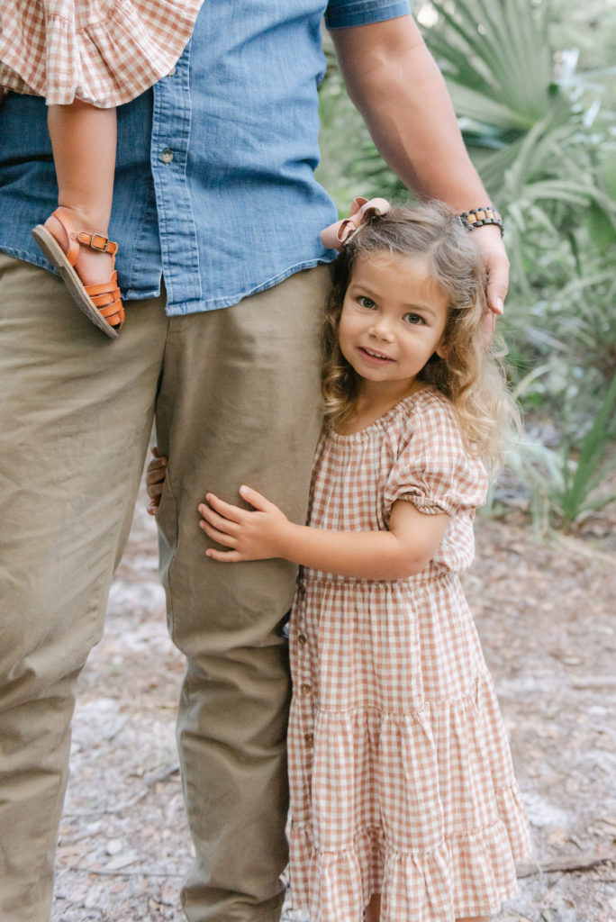 Daughter holding dad's leg