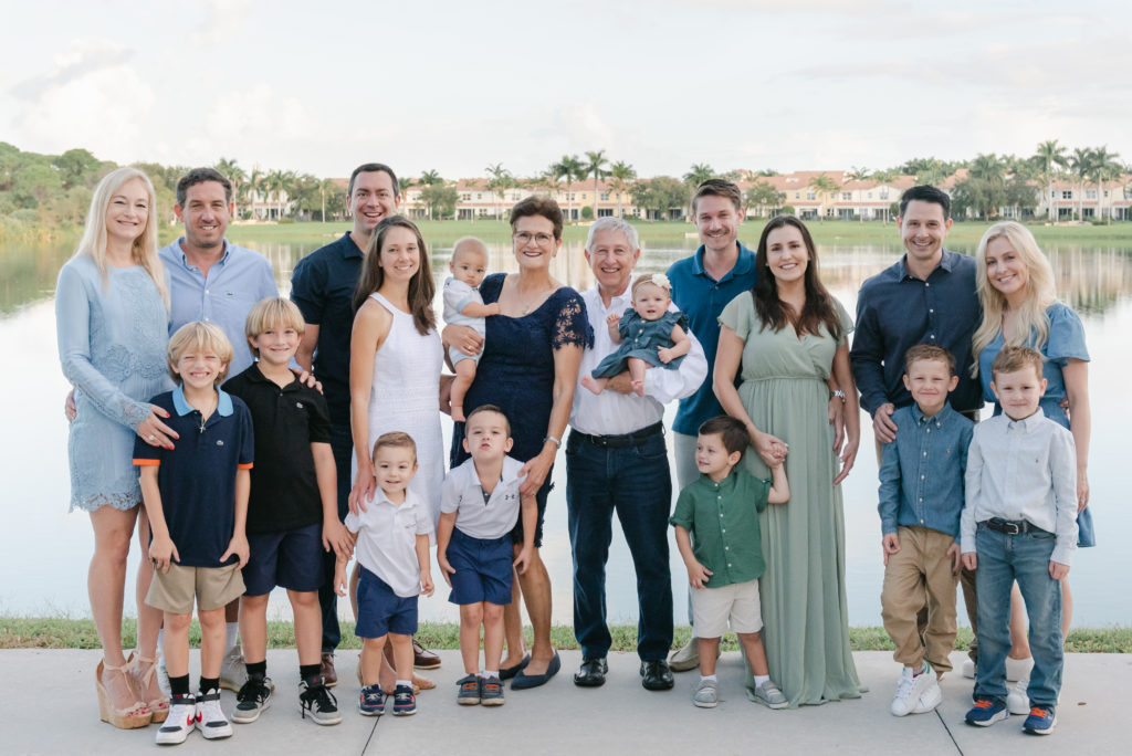 Extended family standing in front of a pond by Palm Beach family photographer