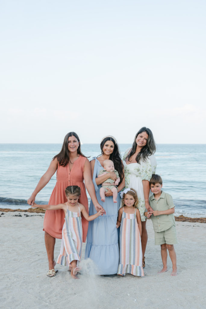 Three sisters and their children on the beach by Palm Beach family photographer