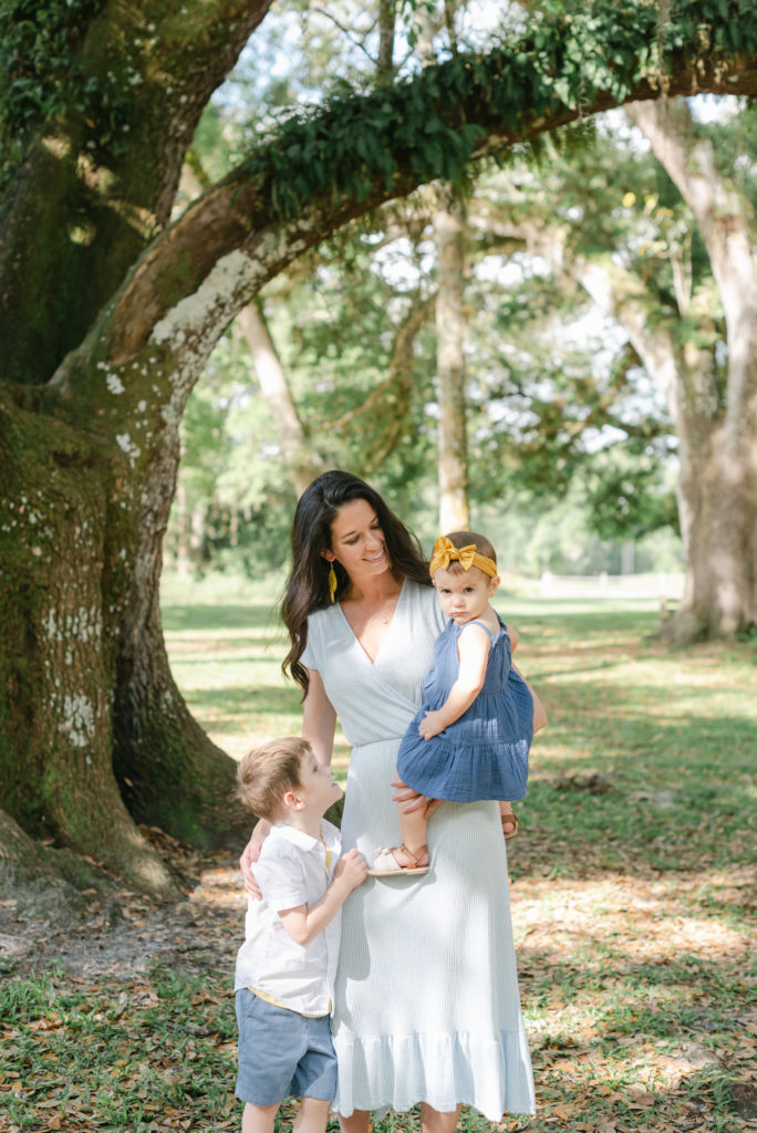 Mom holding daughter with arm around son by Jupiter photographer