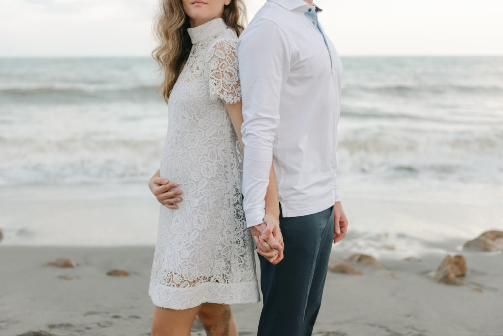 Holding hands and woman holding belly by Jupiter photographer