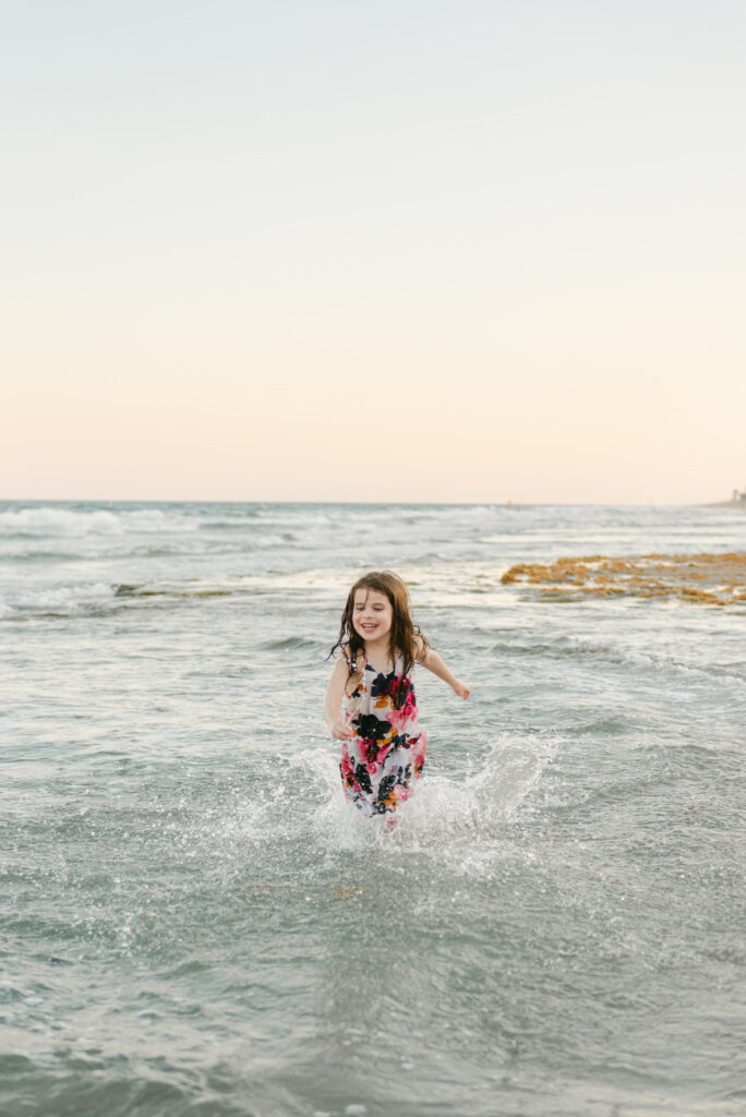 Little girl running in the ocean