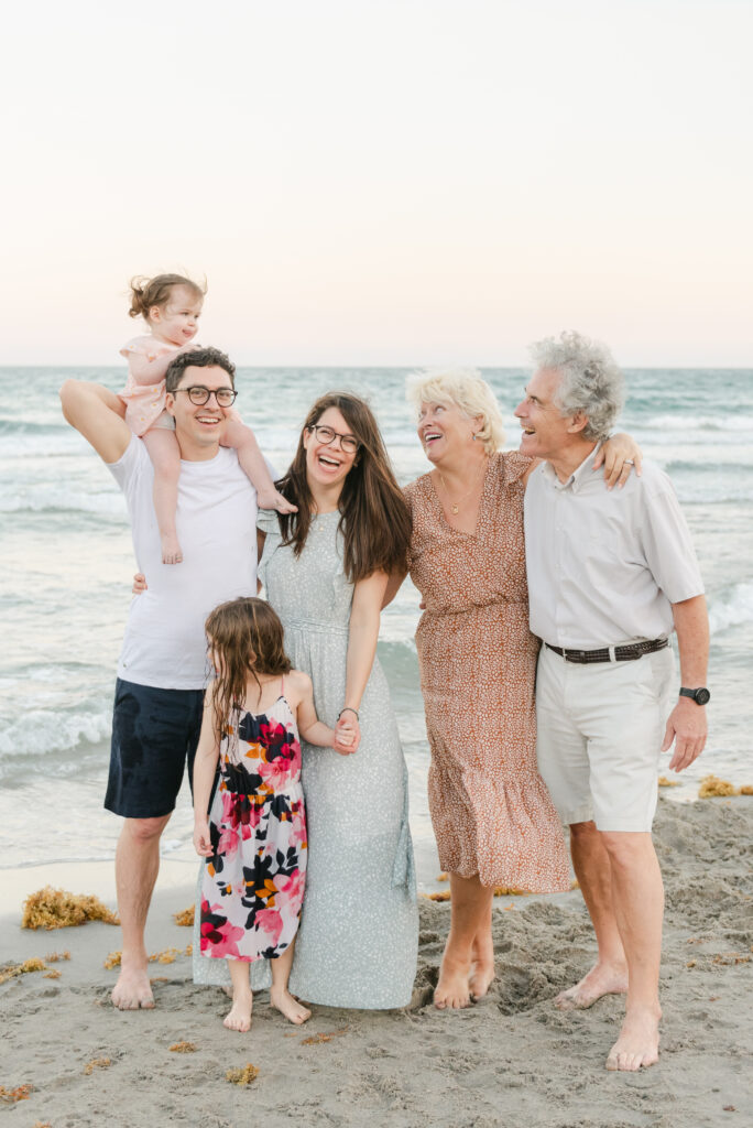 Extended family on the beach laughing