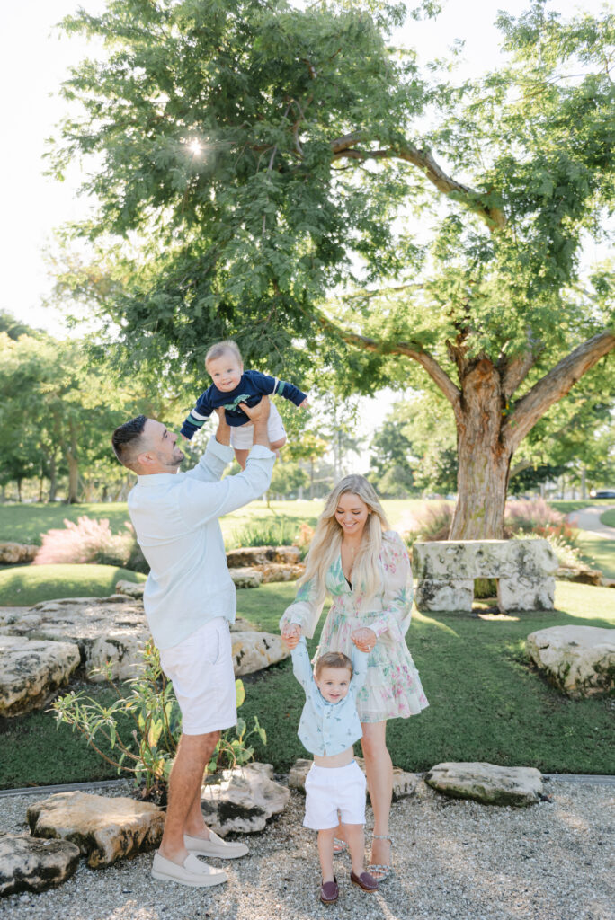 Dad lifting up son and mom spinning boy