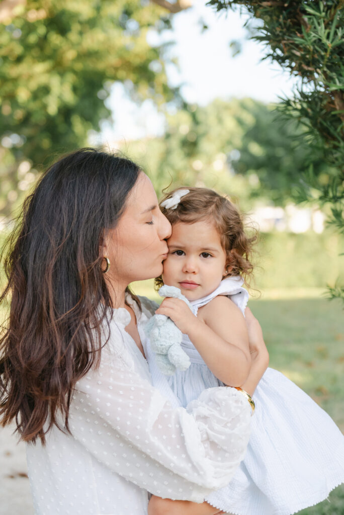 Mom kissing her little girl