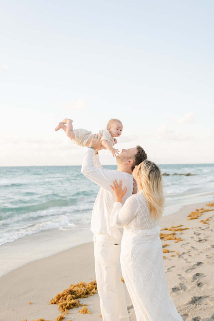 Dad holding up son, mom holding onto dad's back