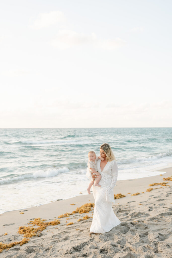 Mom walking with son along the beach